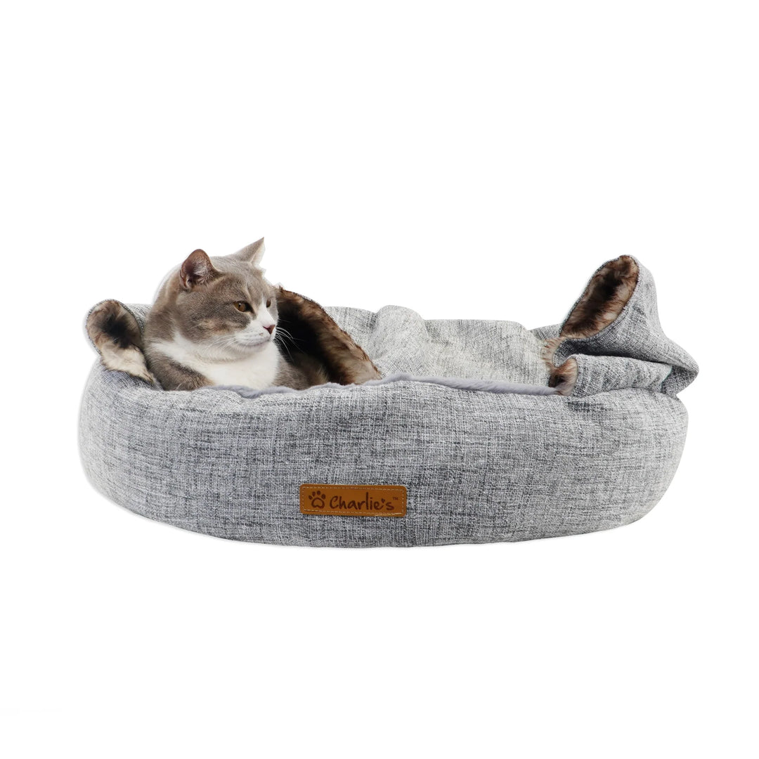 Cat comfortably sleeping in Charlie's Snookie Hooded Pet Bed – Light Grey.