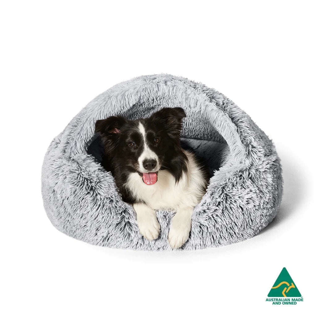 Dog nestled in the Snooza Calming Hoodie Cuddler Dog Bed, showcasing the deep, calming hooded design