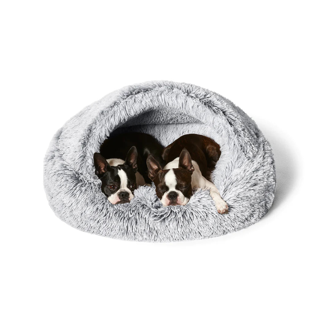 Dogs sleeping in the Snooza Calming Hoodie Cuddler Dog Bed, showcasing the deep, calming hooded design