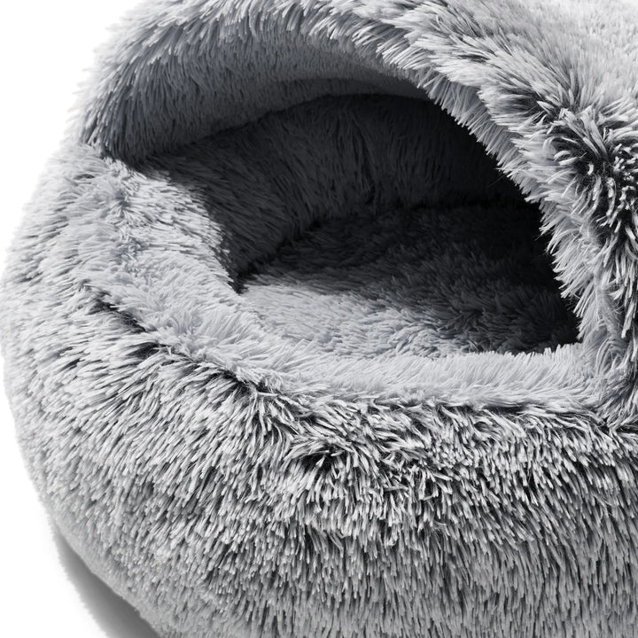 Close-up of the opening of the Snooza Calming Hoodie Cuddler Dog Bed, revealing the cozy, faux-fur lined interior and deep hooded pocket