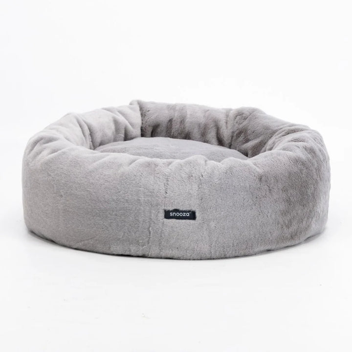 Frontal image of the Twilight Snooza Luxe Fur Cuddler, featuring the Snooza logo and the bed's soft, rounded design.