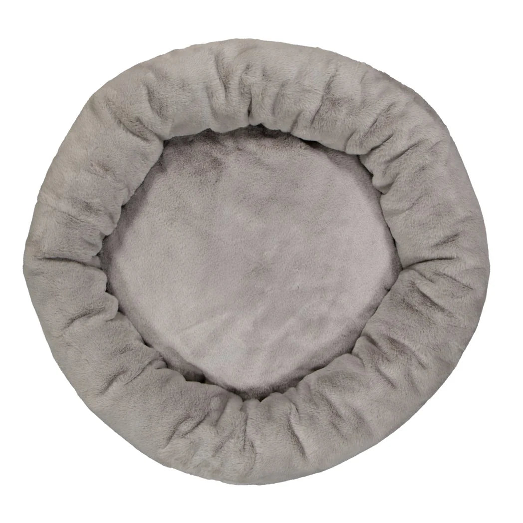  Overhead image of the Twilight Snooza Luxe Fur Cuddler, showcasing its comfortable donut shape and plush surface.