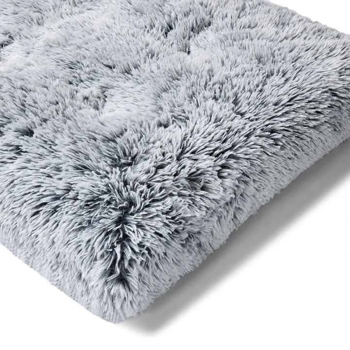 Close-up of Dog on Snooza Calming Multimat - Silver Fox: A detailed view of the soft, long pile faux fur texture.