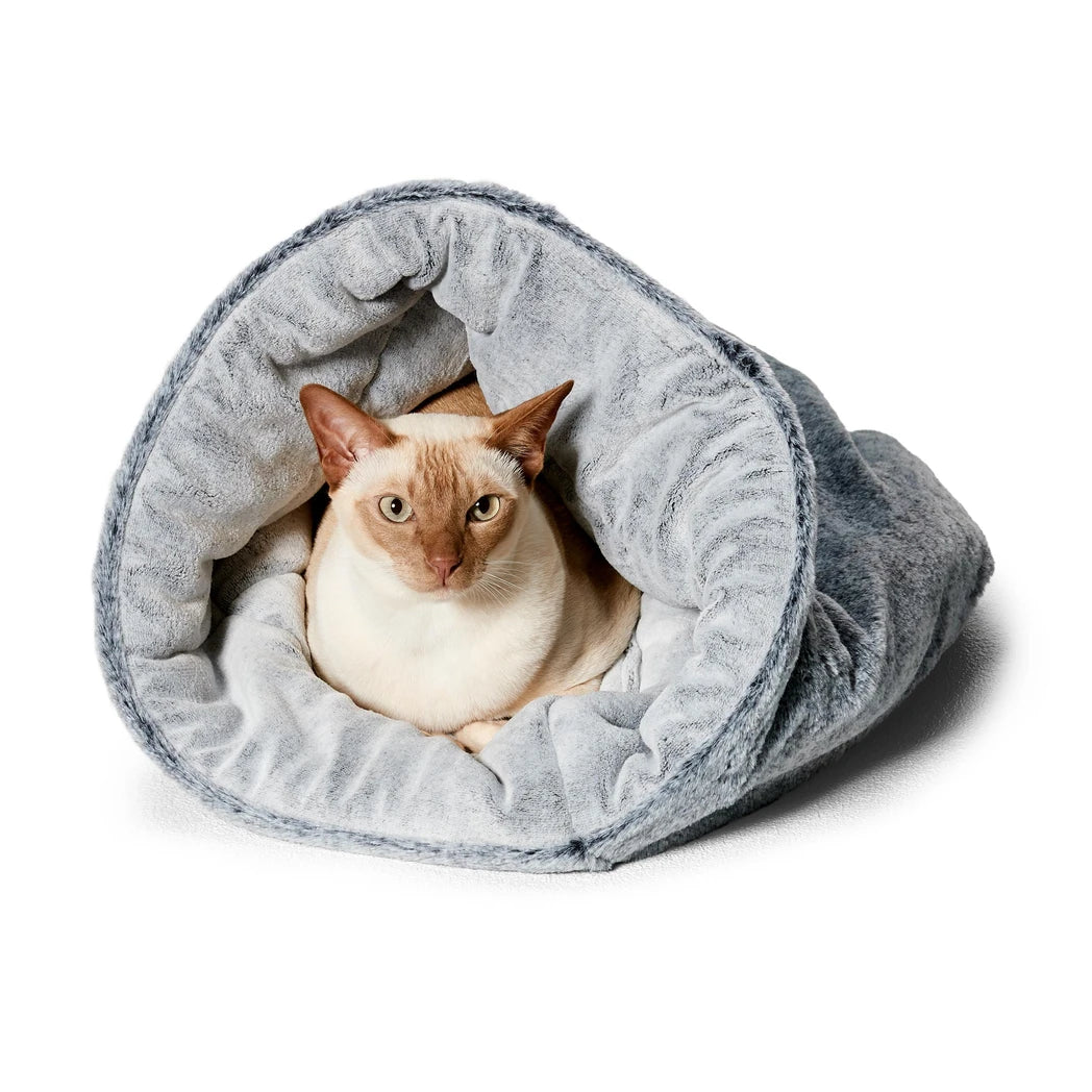 Snooza Chinchilla Cat Bed with a cat inside, demonstrating the cozy and luxurious faux fur interior.