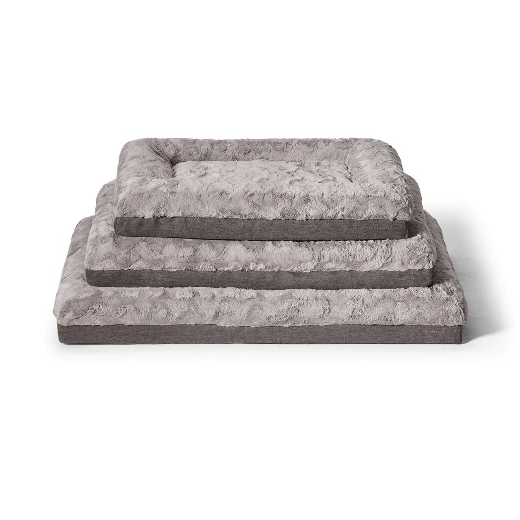 Stacked sizes of the Snooza Ultra Comfort Lounge pet bed, showcasing different dimensions and the luxurious faux-fur texture.