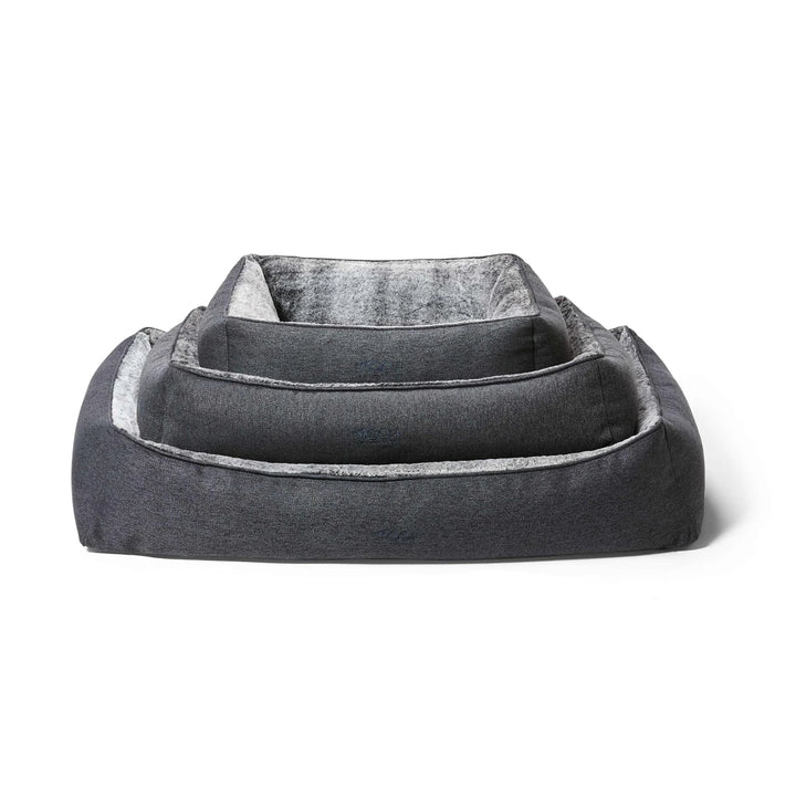 All three sizes of Snooza Ortho Snuggler Dog Beds stacked on top of each other.