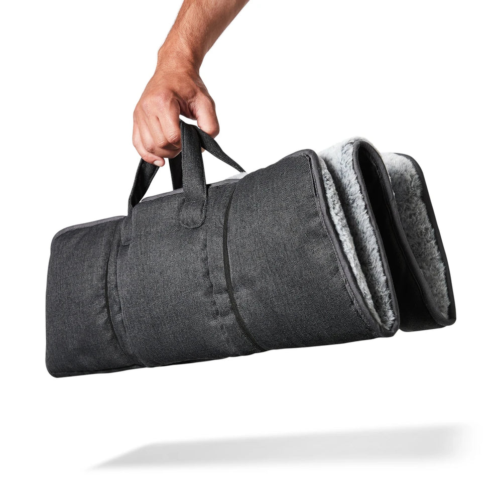 Snooza Travel Mat in Charcoal folded neatly, showcasing its compact and portable design.