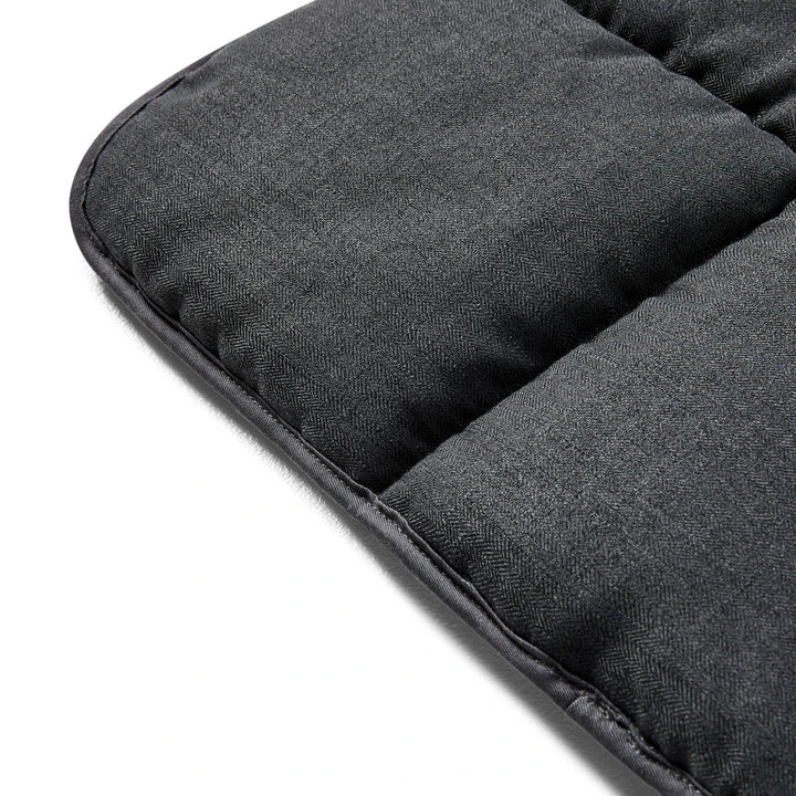 Close-up view of the reverse side grey exterior of the Snooza Travel Mat.