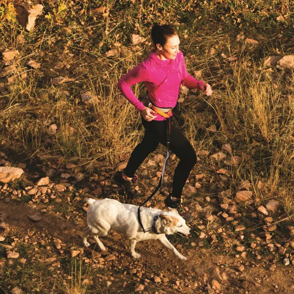 Runner with dog using Kurgo Springback Leash for smooth, controlled runs.